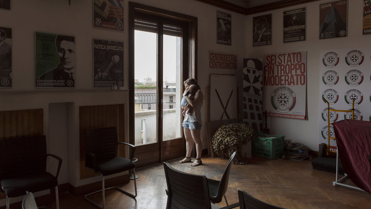 Estella and her four-month-old inside their squat house, which is also the headquarters of CasaPound, Italy's largest neo-Fascist movement. The walls are covered in ultra-nationalist posters. Estella and her four-month-old inside their squat house, which is also the headquarters of CasaPound, Italy's largest neo-Fascist movement. The walls are covered in ultra-nationalist posters.